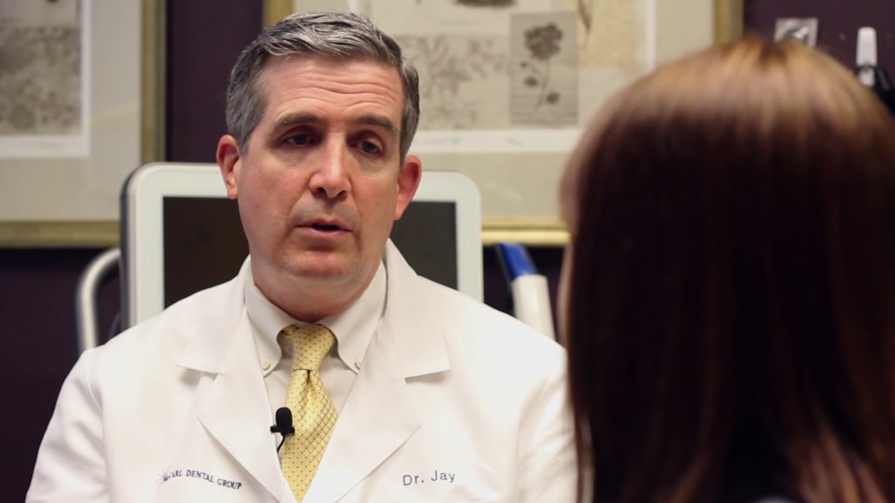 Doctor Jay McCarl talking to a dental patient