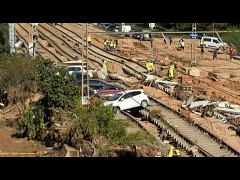 Cars sit on damaged rail tracks after deadly Spain flooding | AFP