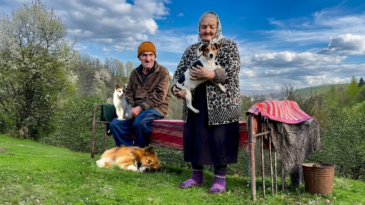 Happy old age of an elderly couple in a mountain village far from civilization