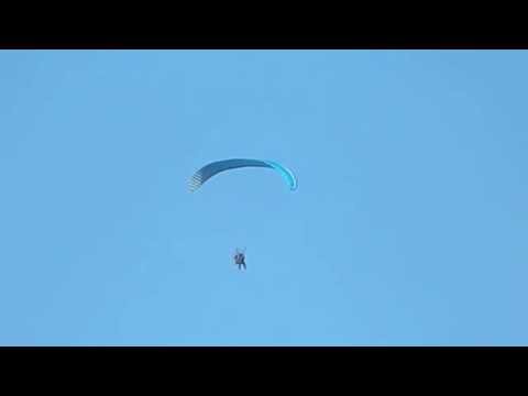 Paraglider with motor over Prestatyn Prom Denbighshire Wales UK