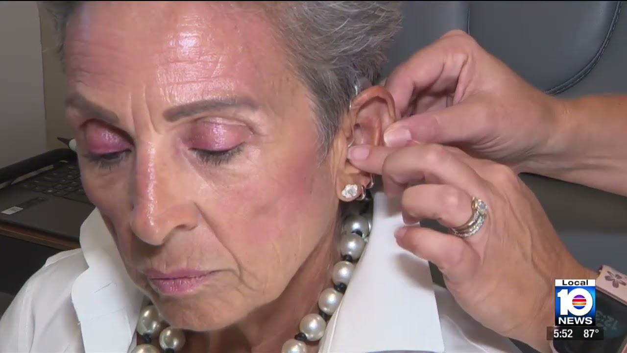 Dr. Rossetti fitting a hearing aid on Local 10 News
