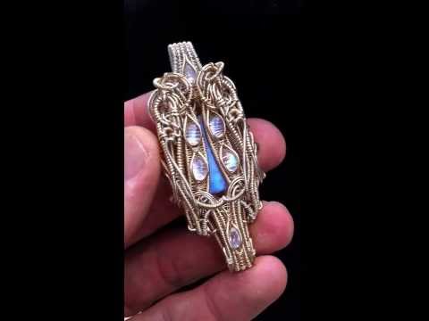 Symmetrical double sided quad directional wire wrap.  Gemstone carving by Pedro Michel