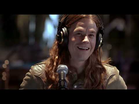 Rock Star trailer montage: rehearsal room morphs into arena catwalk as a Steel Dragon chorus hits
