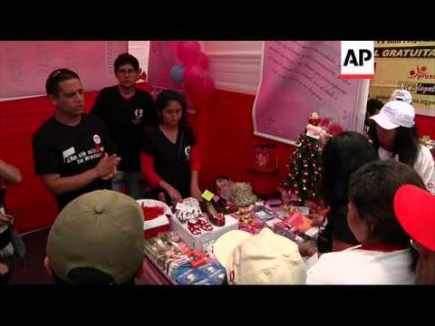 Rio landmarks lit in red to mark world AIDS day; stalls in Lima hand out condoms
