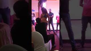 A girl dancing in bra without pa people throw mone
