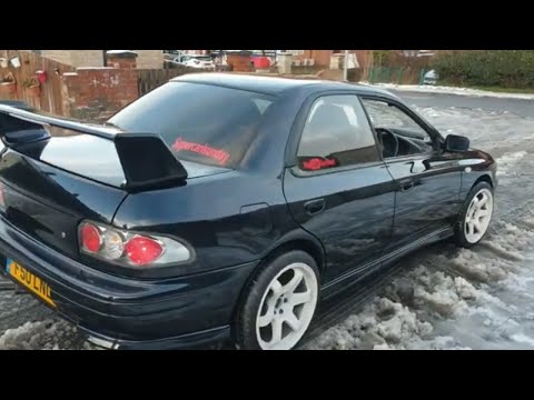 Subaru Impreza restoration. New rear wheel arches and full respray process. BMW Schwarz black!
