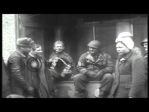 American soldiers listen to a Soviet soldier playing an accordion after capture o...HD Stock Footage