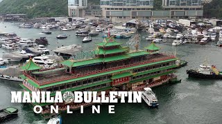 Aerial shot of Famed Hong Kong floating restaurant being towed away