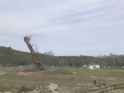 When the demolition goes wrong: Tower buries excavator