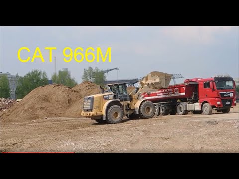 Wheel loader CAT 966M wheel loader loads truck