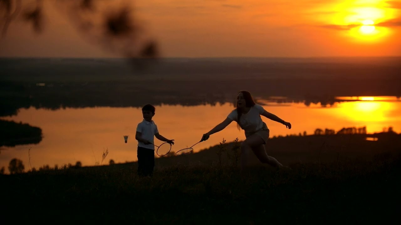 No Copyright Siblings playing badminton in the sunset | Stock Footage Video