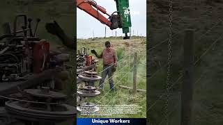 Barbed wire fencing installation: farmer using machine for pasture fencing