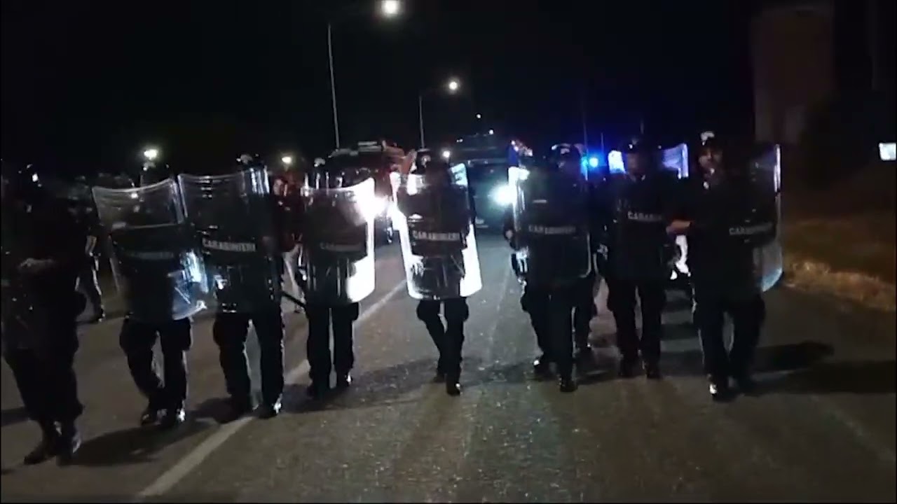 THE TRUCK DEPARTED WITH ITS "ACID" LOAD TO SCRATCH THE SACRED FACE OF SARDINIA. RIOT POLICE AT THE PORT OF ORISTANO