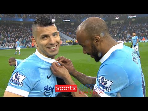 Fabian Delph helping Sergio Aguero with his buttons