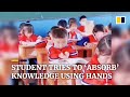 Student in China tries to ‘absorb’ knowledge from book using hands