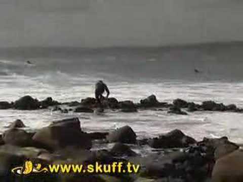 Dorko surfer gets nailed against rocks!