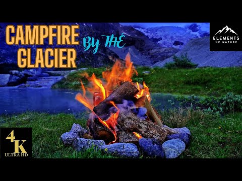 Crackling campfire by the magical Moiry Glacier surrounded by an ice-blue lake