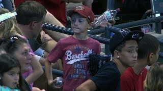 Kid misses ball, another gives him souvenir