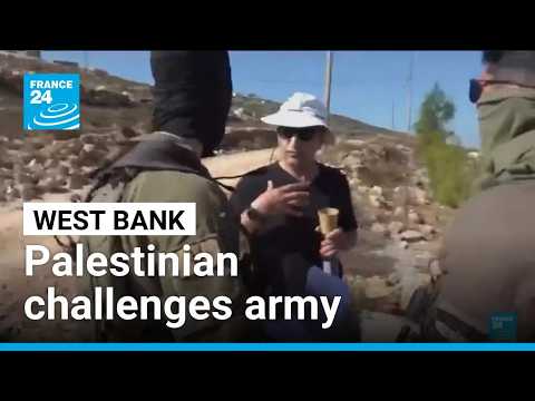 Palestinian American challenges Israeli army outside his home in the West Bank