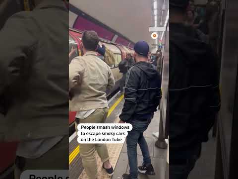 Passengers escape smoky London Tube cars at Clapham Common station