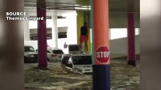 Man stranded on taxi during flooding