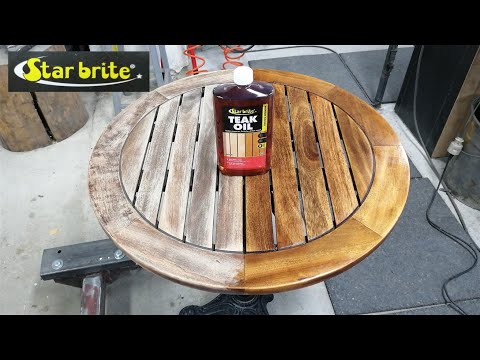 oiling a wooden table with Star brite teak oil