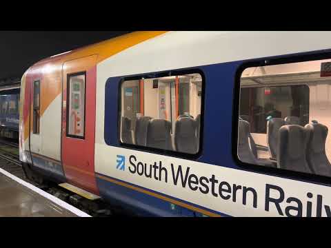 Class 444 arrives and departs Feltham for Woking