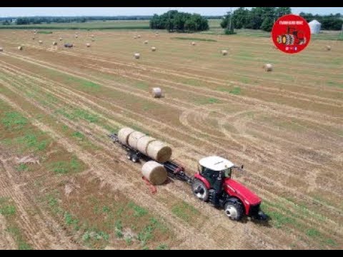 Picking up Round Bales of Wheat Straw near Annawan Illinois