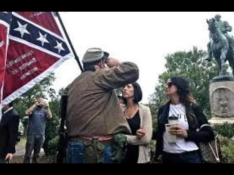 The man with the flag of the Confederacy - Allen, Armentrout protects the monument to General Lee