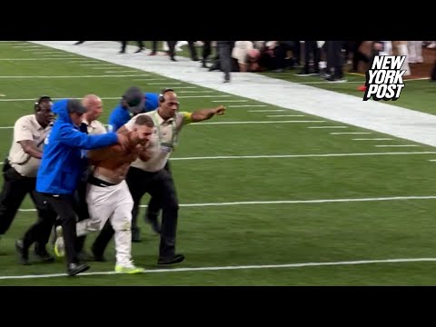 Super Bowl Streakers Smile As They Are Escorted Off The Field