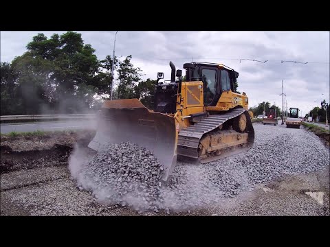 CAT D6XE spreads gravel with grader O&K