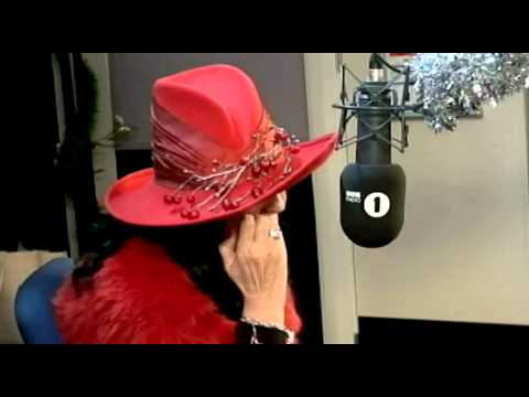 Greg James impersonates Hilary Devey infront of her.