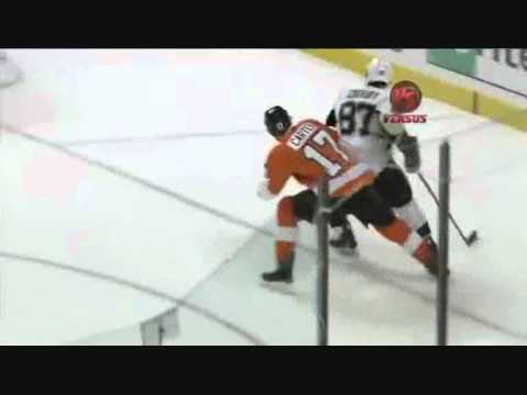 Jeff Carter squashes Crosby against the boards