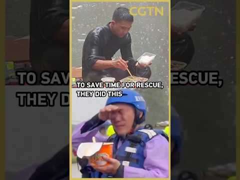 Rescuers eat in the rain in China's flood-hit Guangxi