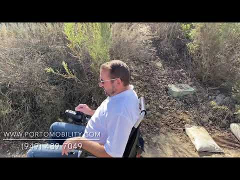 RANGER DISCOVERY Portable Power Wheelchair driving over trail through dirt, sand & uneven terrain.