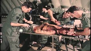 Doctors and Nurse in Vietnam treat a severely wounded United States soldier. HD Stock Footage