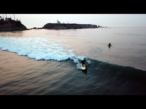 Aerial flight of Coos Bay and surfing