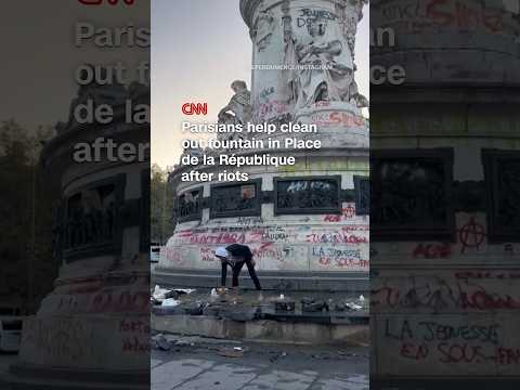 Parisians help clean out fountain in Place de la République after riots