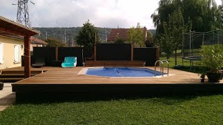 piscine hors sol construction. Terrasse bois. Pare vue. panneaux composite
