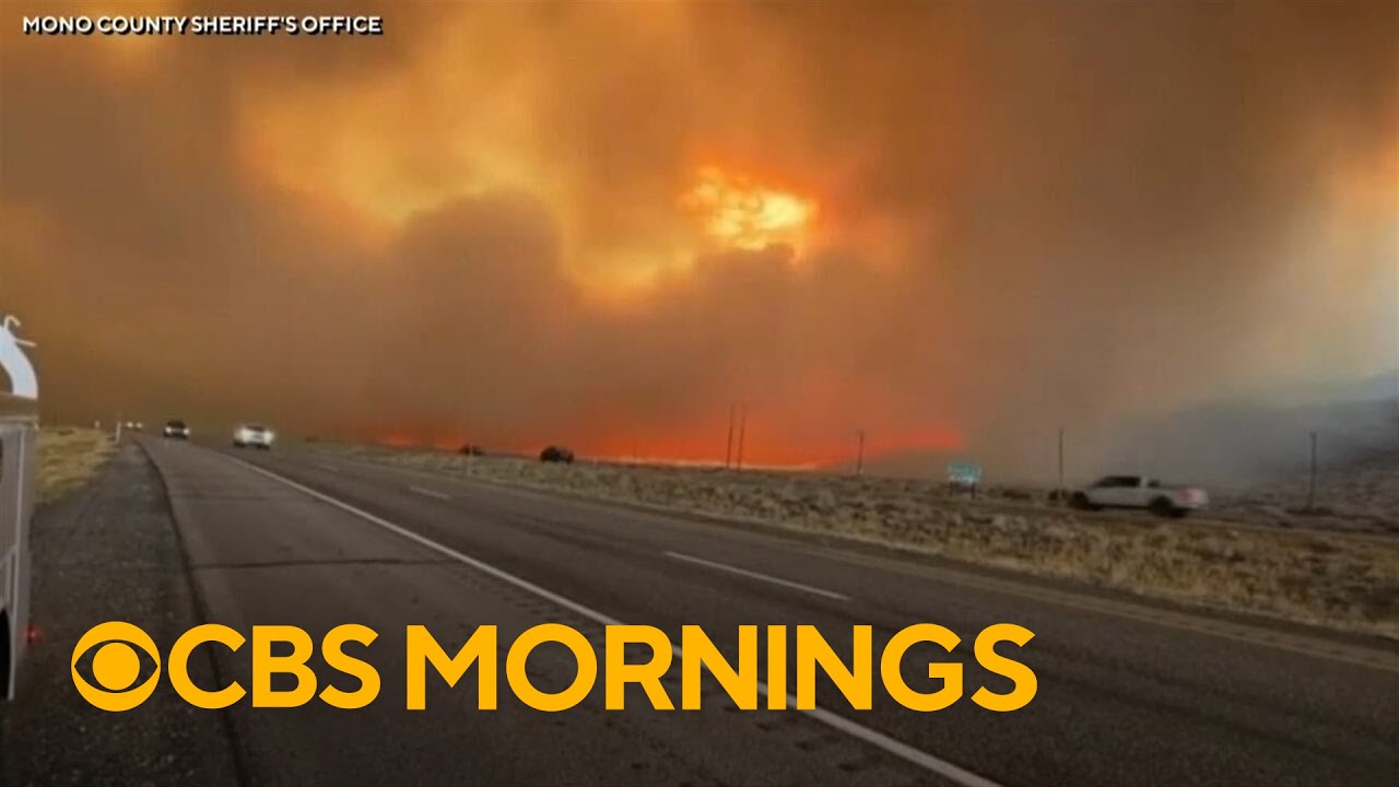 California wildfire explodes as storm threatens mudslides in southern part of state