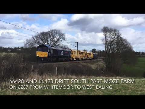 DRS 66428 and 66423 drift south past Moze Farm on 6Z87