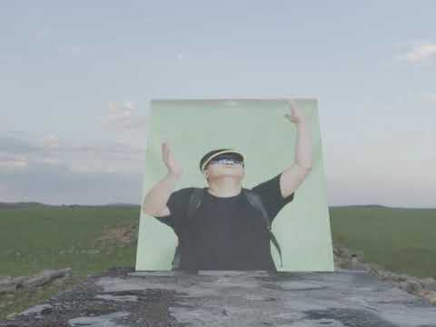 A greenscreen video projected on a transparent mesh plane