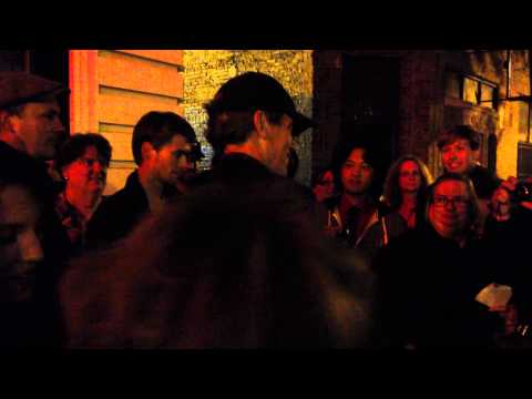 Hugh Laurie signing a phone and cane.