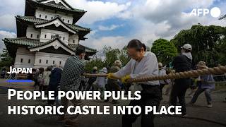 數千日人循古法拉動400噸城堡塔樓 助其歸位