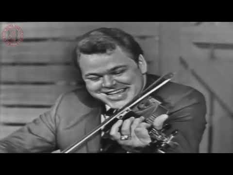 Roy Clark playing guitar, banjo and fiddle