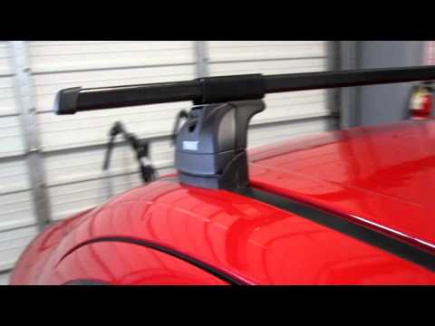 Suzuki SX4 with Thule 460 Podium Square Bar Roof Rack by Rack Outfitters