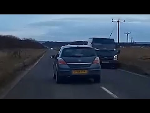 Impatient driver has near-miss with oncoming traffic while overtaking cars on a busy road