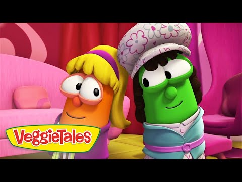 Two VeggieTales characters pose together in a colorful pink set—a carrot with blonde hair and glasses beside a green cucumber wearing a floral hat.