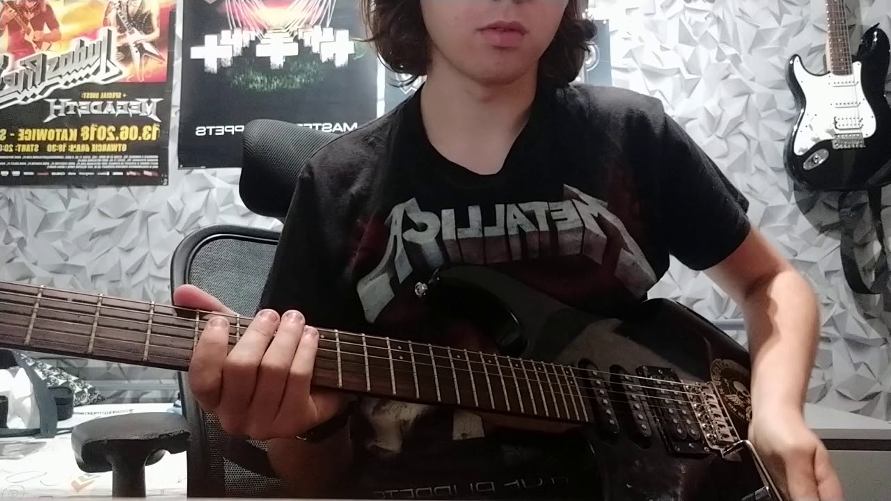 Young boy play master of puppets in metallica t-shirt
