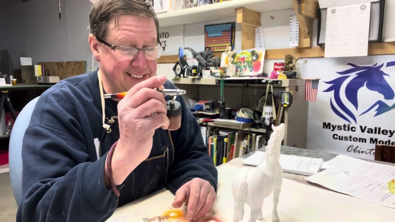 Applying a base coat to a resin model with an airbrush.  Seunta Fraxinus is the model.